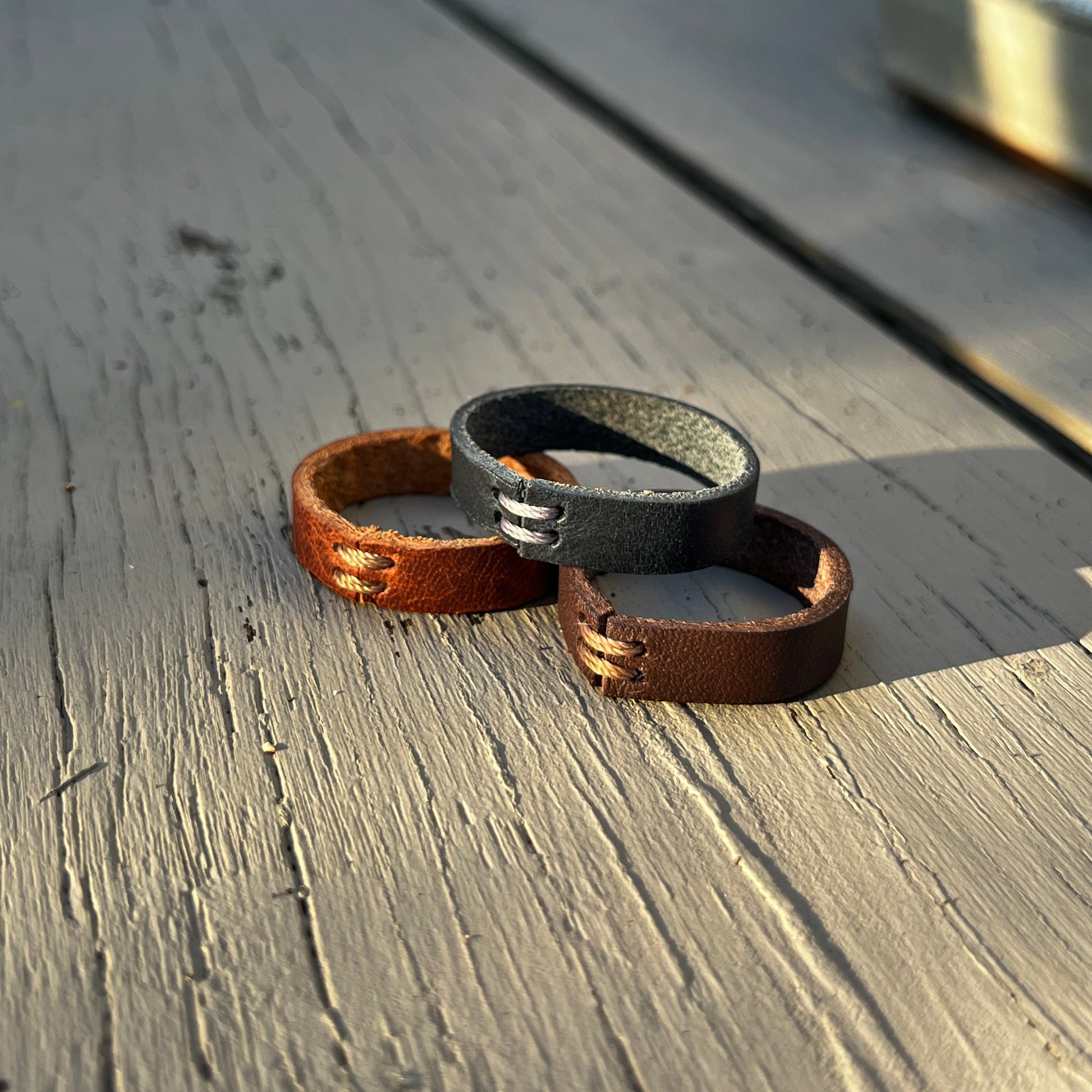 Close-up of a leather Rings on wooden surface